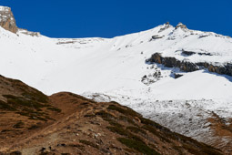 The goal was to get to Kang La (pass) but it was impassible due to snow. The actual pass is just to the right of the rock formation on the left. The snow is unusual this time of year; it should be dry and barren.        28°40'35